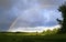 Sky and rainbow after thunderstorm over a wide country landscape