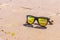 Sky is reflected in sunglasses, beach