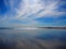 Sky reflecting on the sand at a beach