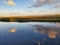 Sky reflections across calm waters of the Marsh
