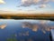 Sky reflections across calm waters of the Marsh 2