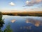 Sky reflections across calm waters of the Marsh 3
