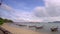 Sky and Sand of Beach Andaman Sea. White clouds and traditional Thai boats - longboat on the water. 4K