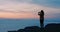 Sky, sunset and hiking with woman silhouette, landscape photography with smartphone, fitness and hike on cliff with sea