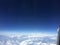 Sky with white clouds outside the window seen on the plane