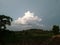 Sky with white rainy clouds in the green farmland. close up view of cloud,