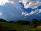 Sky with white rainy clouds in the green farmland. close up view of cloud,