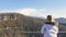 Skybridge observation deck. Woman enjoing sunlight and scenery view of the mountains