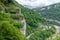 Skybridge suspension bridge over a gorge over an abyss with a river and serpentine road. Skypark, Sochi, Russia