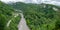 Skybridge suspension bridge over a gorge over an abyss with a river and serpentine road. Skypark, Sochi, Russia