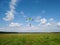 A skydiver with a bright multicolored parachute flies against the background of a blue sky