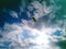 A skydiver with a bright multicolored parachute flies against the background of a blue sky