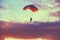 Skydiver On Colorful Parachute In Sunny Sky