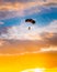 Skydiver On Colorful Parachute In Sunny Sunset