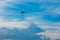 Skydiver on colorful parasailing in blue sky over the sea