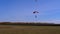 Skydiver flying with a parachute and landed on the ground