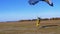 Skydiver flying with a parachute and landed on the ground. Slow Motion