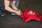 Skydiver Folding Up His Red Parachute on the Ground