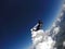 Skydiver jumping free with the clouds