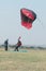 Skydiver landing next to another with open parachute.