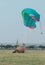 Skydiver making a hard landing with open parachute.