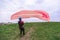 Skydiver pulls parachute behined him after landing