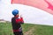 Skydiver pulls parachute behined him after landing