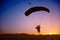 Skydiver silhouette under parachute