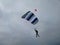Skydiver in the sky before landing on the background of a cloudy sky with gray clouds with a parachute