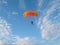 A skydiver with a sports parachute wing flies before landing in the summer