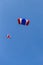 Skydiver team in colorful parachute gliding after free fall jump