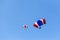 Skydiver team in colorful parachute gliding after free fall jump