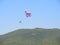 skydivers against the sky and mountains