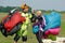 Skydivers carries a parachute after landing