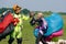 Skydivers carries a parachute after landing