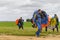 Skydivers carries a parachute after landing.