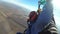 Skydivers flying in tandem under the open parachute