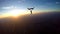 Skydivers having fun at the amazing sunset 4K video