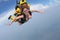 Skydiving. Girl and instructor are flying in the sky.