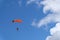 Skydiving. A parachute is in the blue sky.