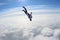 Skydiving. Skydiver is falling above clouds.
