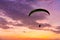 Skydiving sunset landscape of parachutist flying in soft focus. Para-motor flying silhouette with sun set. Silhouette of paraglide