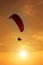 Skydiving sunset landscape of parachutist flying in soft focus. Para-motor flying silhouette with sun set. Silhouette of paraglide