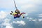 Skydiving. Tandem jump. Instructor and indian passenger.