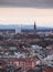 Skyline of city Munich with church Mariahilfkirche and snow covered Alps in background during sunset, Bavaria