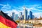 Skyline cityscape of Frankfurt, Germany during sunny day with german flag. Frankfurt Main in a financial capital of Europe