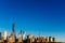 Skyline of downtown Manhattan under blue sky, at sunset, in New