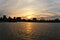 A skyline of Montreal Old Port and Downtown at sunset. Reflections of sun rays on Saint Laurent river