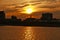 A skyline of Montreal Old Port at sunset. Foreground is Saint Laurent river