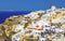 Skyline of Oia, traditional white architecture with windmills, greek village of Santorini, Greece. Santorini is island